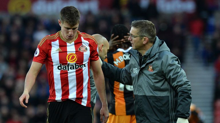 SUNDERLAND, ENGLAND - NOVEMBER 19:  Paddy McNair of Sunderland is helped to his feet by the club physio after sustaining an injury during the Premier Leagu