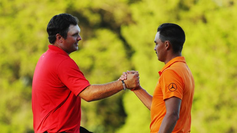 FARMINGDALE, NY - AUGUST 28:  Patrick Reed (L) greets Rickie Fowler on the 18th green after Reed won The Barclays in the PGA Tour FedExCup Play-Offs on the