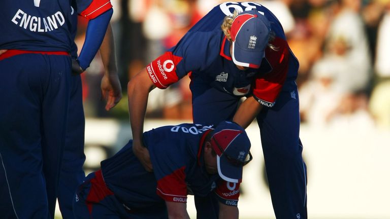 Stuart Broad helps Paul Collingwood - who has just failed to run out Kyle Mills - to his feet