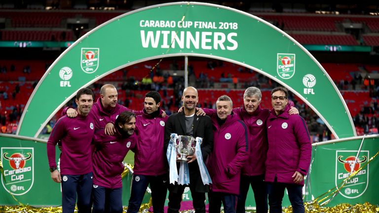 Pep Guardiola and his Manchester City staff with the Carabao Cup trophy