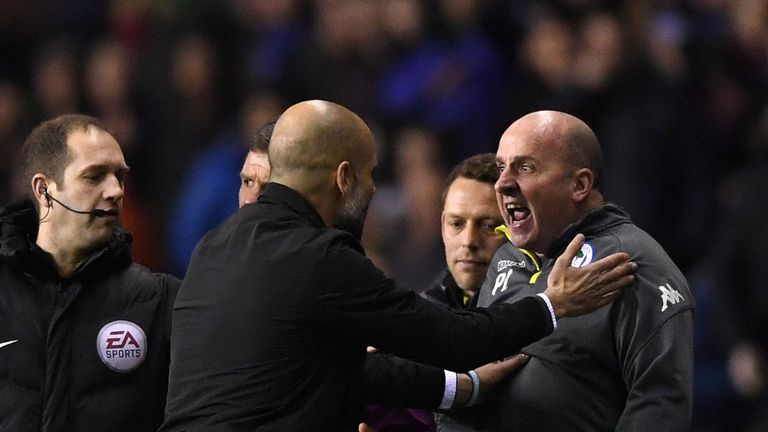 WIGAN, ENGLAND - FEBRUARY 19:  Josep Guardiola, Manager of Manchester City argues with Paul Cook, Manager of Wigan Athletic during the Emirates FA Cup Fift