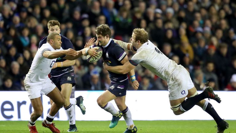 Peter Horne  is tackled by England's Joe Launchbury (R) and Jonathan Joseph 
