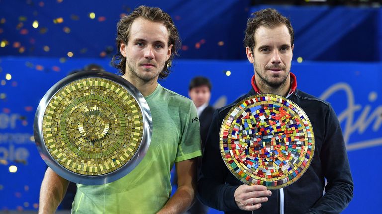 France's tennis players Lucas Pouille (L) and Richard Gasquet pose with their trophy after the final of the ATP World Tour Open Sud de France in Montpellie