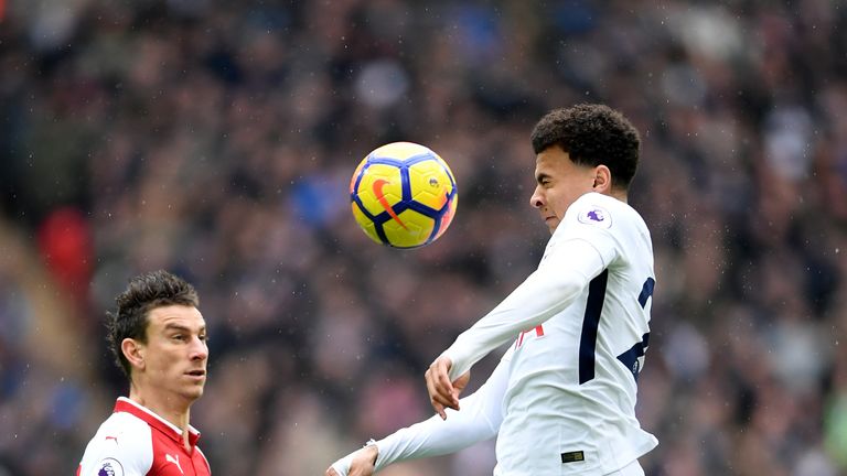Dele Alli and Laurent Koscielny in action during the North London derby at Wembley Stadium