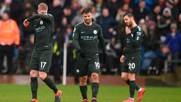 Kevin De Bruyne, Sergio Aguero and Bernardo Silva walk to the centre circle following Burnley's equaliser