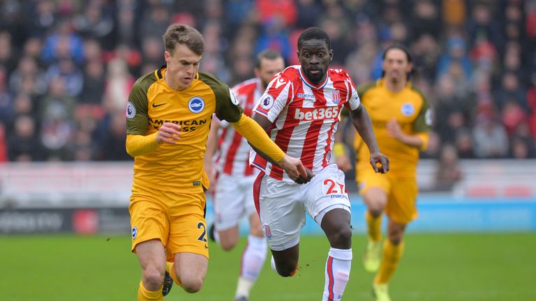 Solly March is chased down by Badou Ndiaye during the Premier League match between Stoke City and Brighton