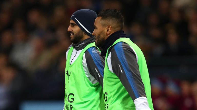 Riyad Mahrez of Leicester City speaks to team-mate Danny Simpson as they warm up