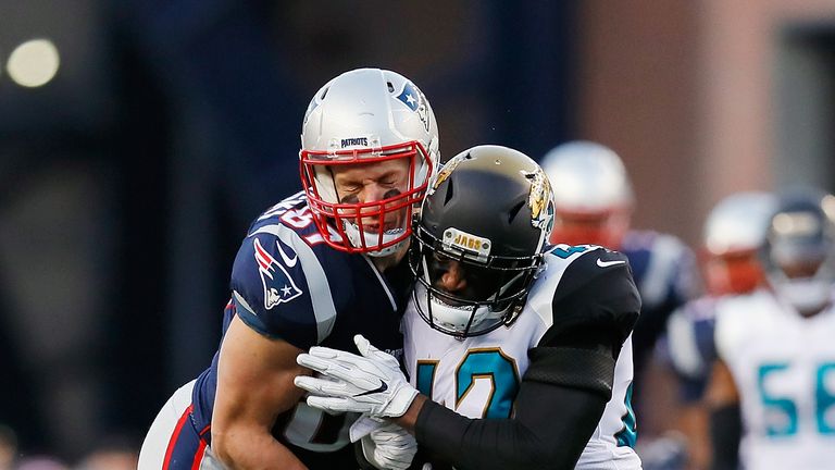FOXBOROUGH, MA - JANUARY 21:  Rob Gronkowski #87 of the New England Patriots is hit by Barry Church #42 of the Jacksonville Jaguars in the second quarter d