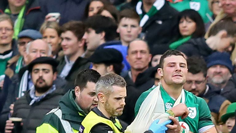 Ireland's centre Robbie Henshaw is helped from the field against Italy