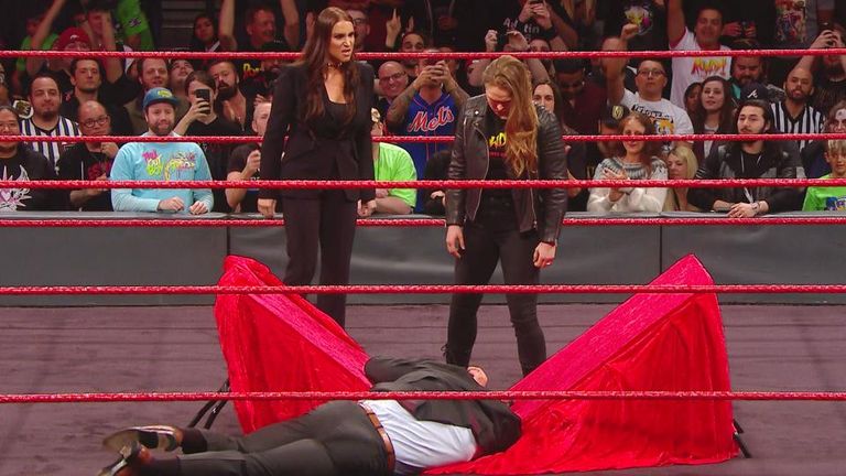 Ronda Rousey looks on after throwing Triple H through a table at Elimination Chamber
