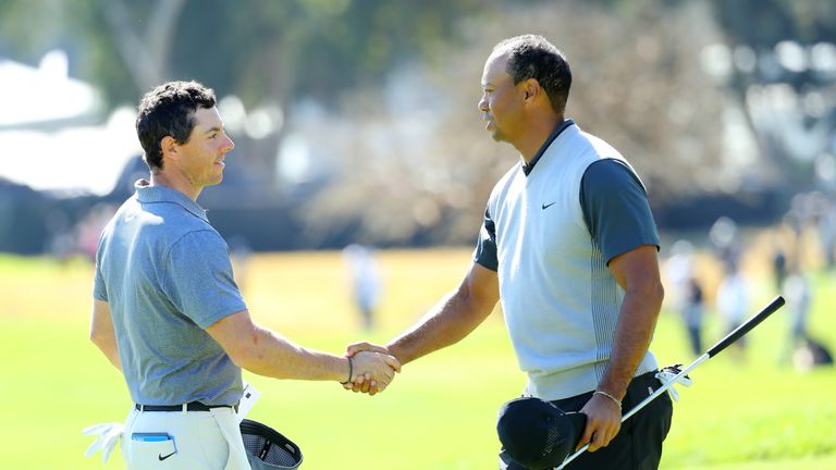 PACIFIC PALISADES, CA - FEBRUARY 15:  Rory McIlroy of Northern Ireland and Tiger Woods shake hands after finishing their round during the first round of th