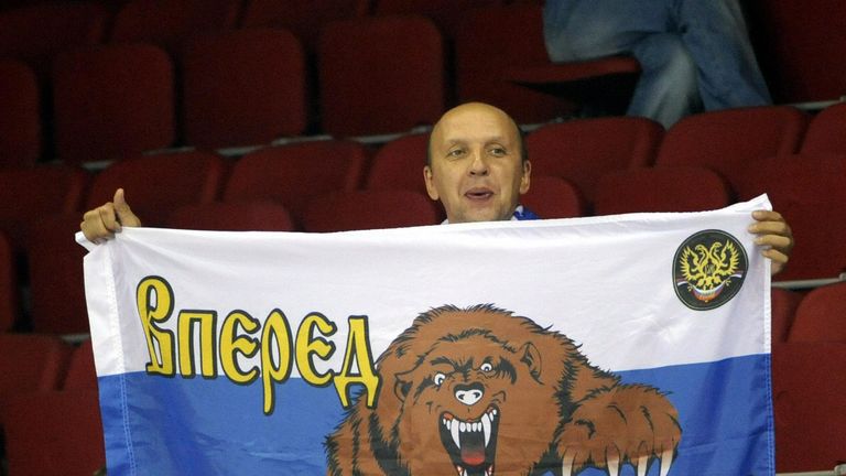 A supporter of Russia displays the Russian flag with a bear and a-Go Russia- catchword on the stand in the Volleyball European Championships Finals group B