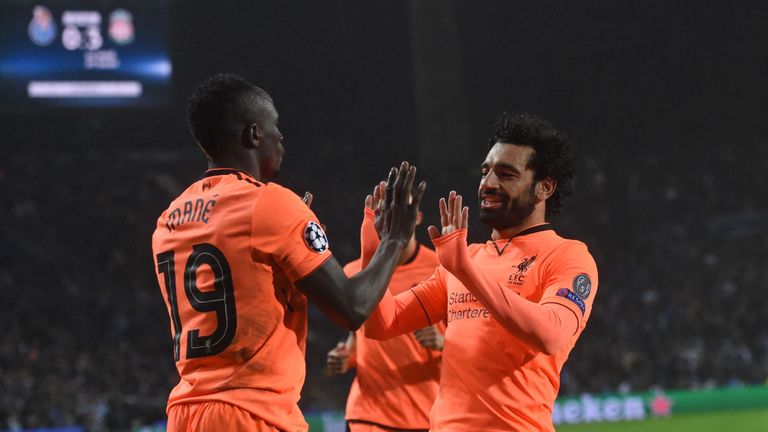 Liverpool's Senegalese midfielder Sadio Mane (L) celebrates with Liverpool's Egyptian midfielder Mohamed Salah after scoring their third goal during the UE