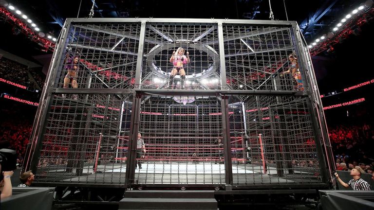 Sasha Banks and Bayley pursue Raw women's champion Alexa Bliss in the Elimination Chamber