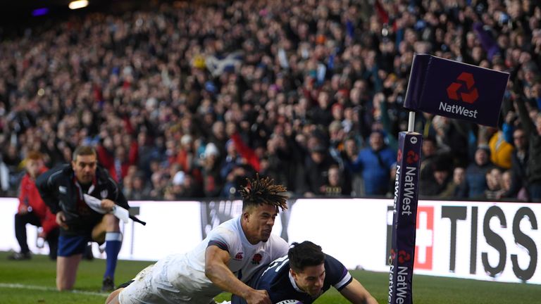 EDINBURGH, SCOTLAND - FEBRUARY 24: Sean Maitland of Scotland scores a try under pressure from Athony Watson of England during the NatWest Six Nations match
