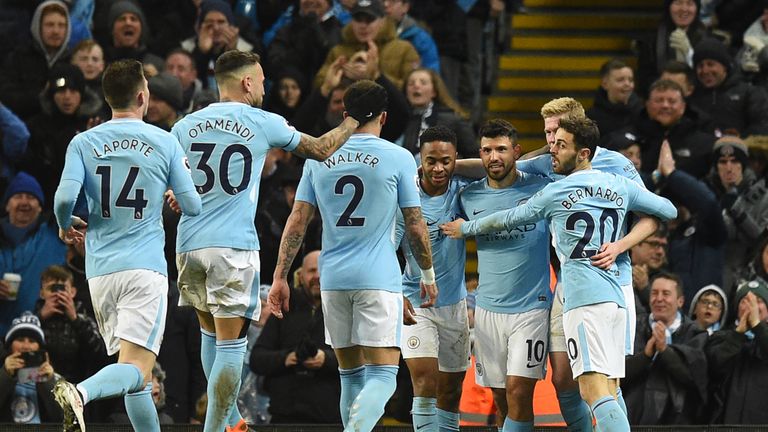 Sergio Aguero (3R) celebrates with team-mates after putting Man City 3-1 ahead