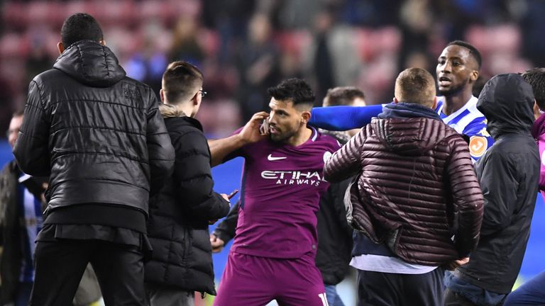 WIGAN, ENGLAND - FEBRUARY 19:  Sergio Aguero of Manchester City is surrounded by fans as he attempts to leave the pitch after the Emirates FA Cup Fifth Rou