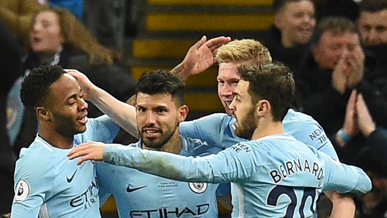 Sergio Aguero celebrates with team-mates after making it 3-1