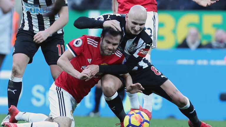 Jonjo Shelvey and Juan Mata during the Premier League match between Newcastle United and Manchester United at St James' Park on February 11