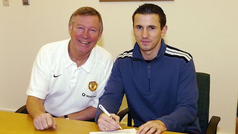 Sir Alex Ferguson poses with new signing Liam Miller at Carrington on January 8, 2004 in Manchester, England. 
