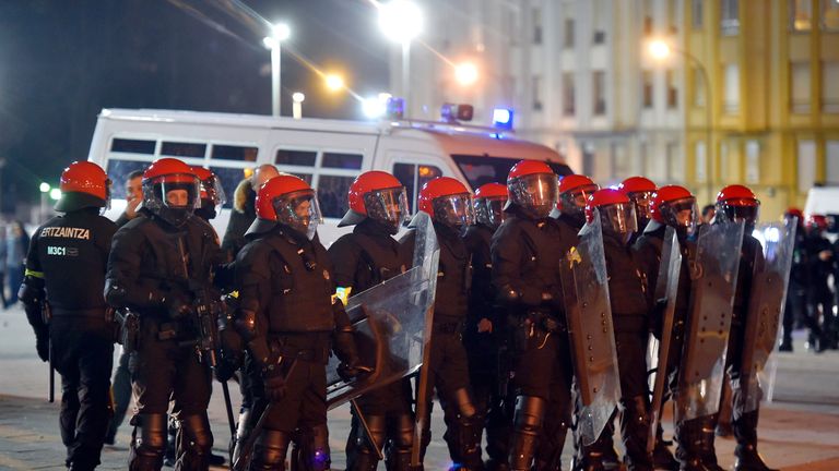 Basque autonomous police officers stand guard outside the San Mames stadium before the Europa League Round of 32 second leg football match between Athletic