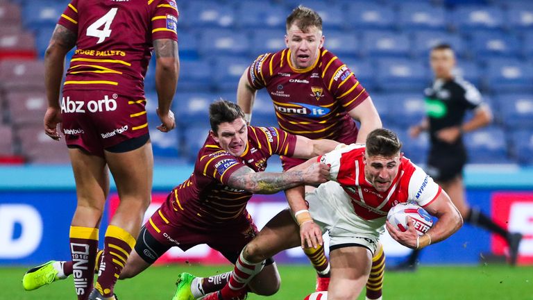St Helens' Tommy Makinson is tackled by Huddersfield's Danny Brough.