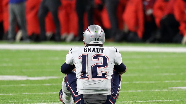 Tom Brady sits on the field of play after fumbling the ball during the fourth quarter against in Super Bowl LII