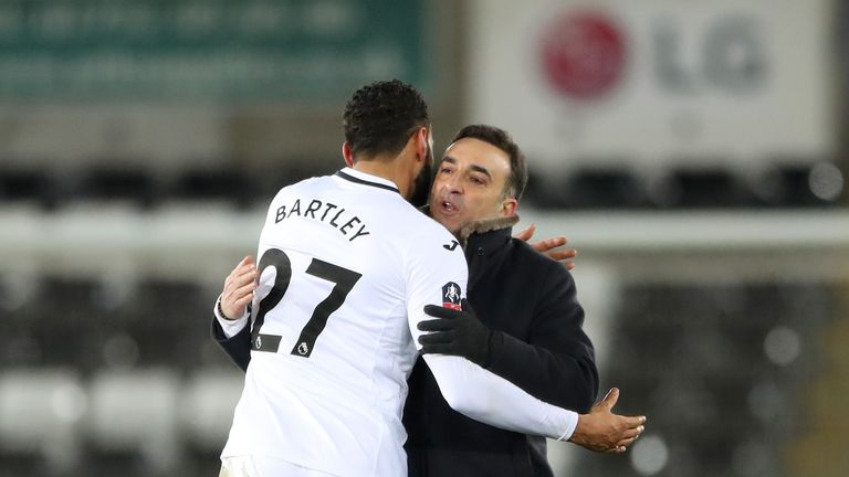 Swansea City's Kyle Bartley and Swansea City manager Carlos Carvalhal celebrate after the final whistle of the Emirates FA Cup, fifth round replay match at