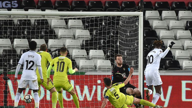 Swansea City's Tammy Abraham (right) scores his side's first goal during the Emirates FA Cup, fourth round replay match at the Liberty Stadium, Swansea.