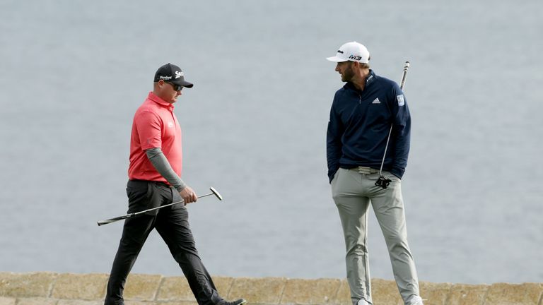 PEBBLE BEACH, CA - FEBRUARY 11:  Ted Potter Jr. (L) and Dustin Johnson walk across the 18th green during the Final Round of the AT&T Pebble Beach Pro-Am at