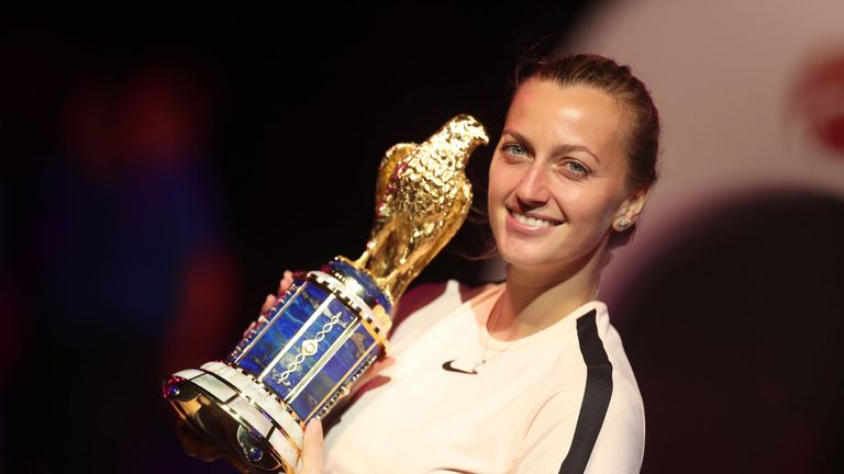 Petra Kvitova of the Czech Republic poses with her trophy on the podium after winning the final of the women's singles at the Qatar Open tennis competition