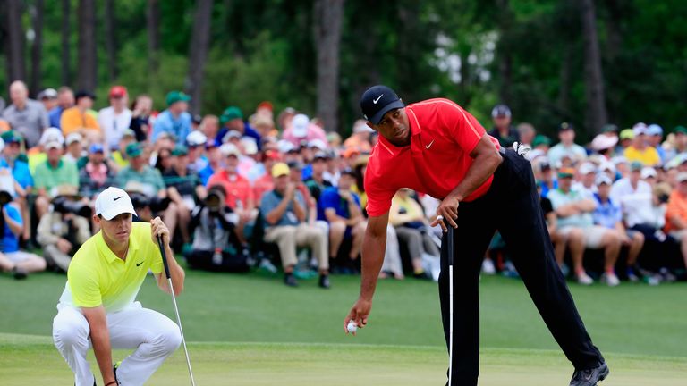 AUGUSTA, GA - APRIL 12:  Tiger Woods of the United States and  Rory McIlroy of Northern Ireland on the 18th green during the final round of the 2015 Master