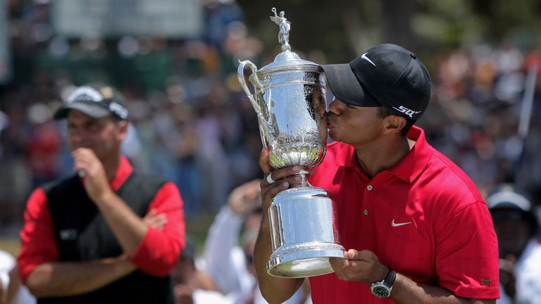 SAN DIEGO - JUNE 16:  Tiger Woods celebrates with the trophy after winning on the first sudden death playoff hole during the playoff round of the 108th U.S