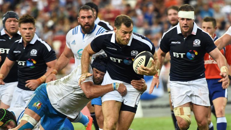 Tim Visser (C) of Scotland runs with the ball away from Italian player during their rugby Test match between Italy against Scotland at the National Stadium