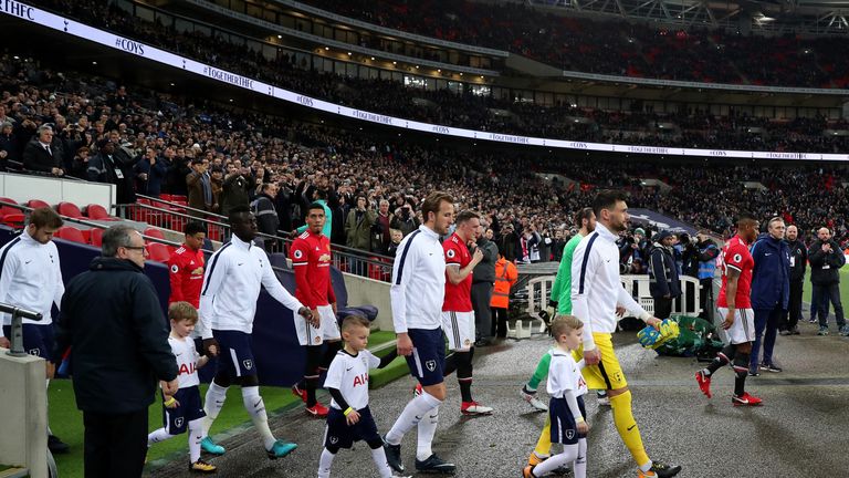 LONDON, ENGLAND - JANUARY 31: Tottenham Hotspur goalkeeper Hugo Lloris and Harry Kane of Tottenham Hotspur walk out onto the pitch before the Premier Leagu