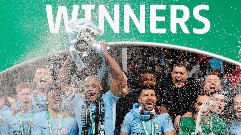 Vincent Kompany lifts the Carabao Cup trophy as Manchester City players celebrate their 3-0 victory over Arsenal