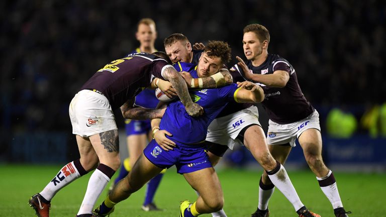 WARRINGTON, ENGLAND - FEBRUARY 01:  Joe Philbin of Warrington is tackled by Brett Delaney, Brad Singleton and Matt Parcell of Leeds during the Betfred Supe