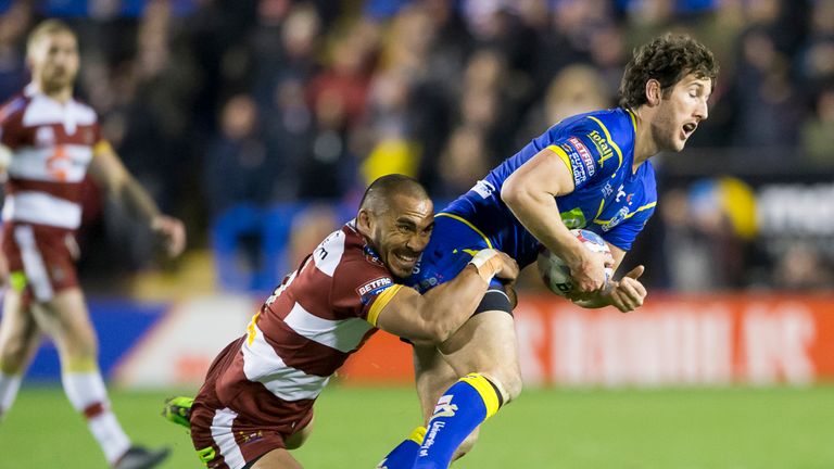 Warrington's Stefan Ratchford is tackled by Wigan's Thomas Leuluai