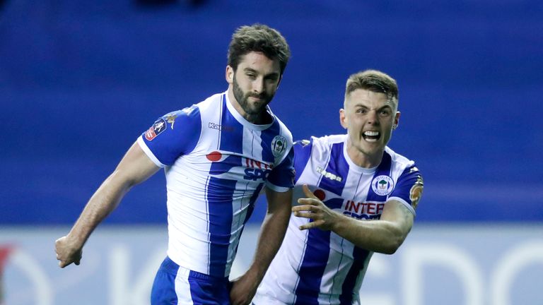 Wigan Athletic's Will Grigg (left) celebrates scoring his side's first goal of the game during the Emirates FA Cup, Fifth Round match at the DW Stadium, Wi