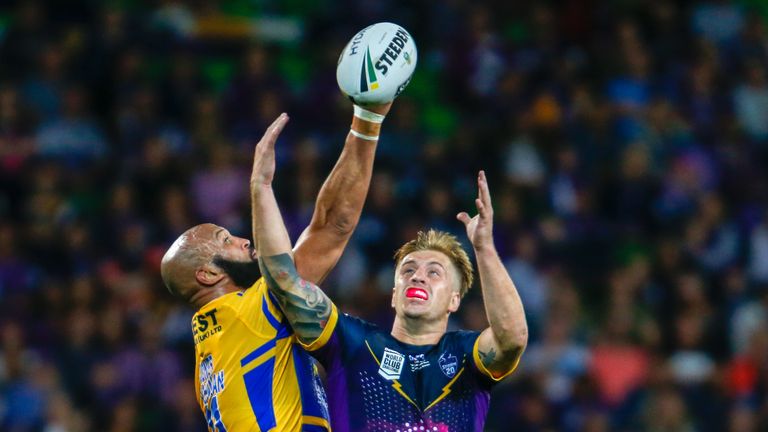 Jamie Jones-Buchanan of Leeds Rhinos and Cameron Munster contest for the ball in the World Club Challenge
