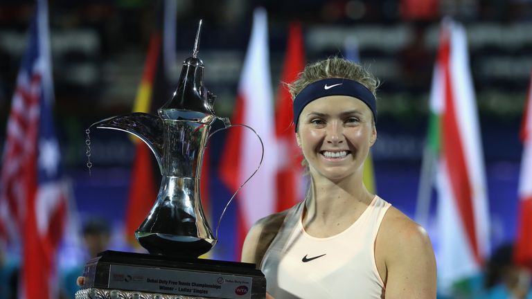Elina Svitolina of Ukraine poses with the trophy after winning the WTA Dubai Duty Free Tennis Championship