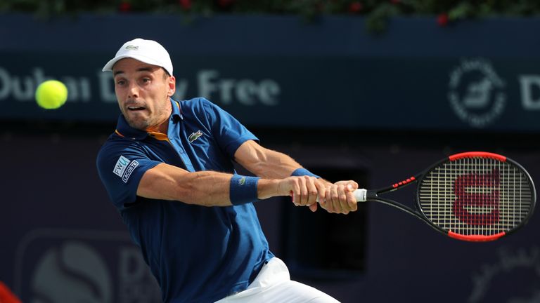 Spain's Roberto Bautista Agut returns the ball to Pierre-Hugues Herbert of France during their Dubai Duty Free Tennis singles match