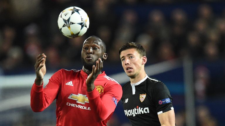 Romelu Lukaku vies with Sevilla defender Clement Lenglet