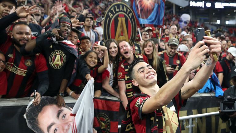 Atlanta United midfielder Miguel Almiron celebrates a 3-1 win with part of a record crowd