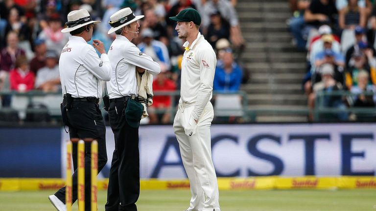 Cameron Bancroft is questioned by umpires Richard Illingworth and Nigel Llong
