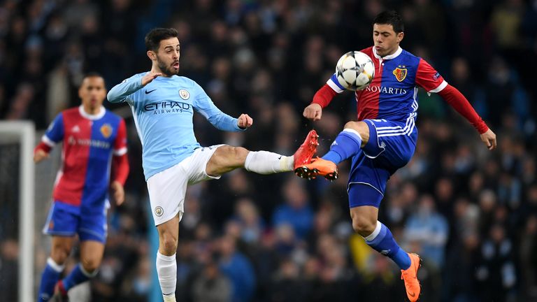 Manchester City's Bernardo Silva and Blas Riveros of Basel battle for the ball