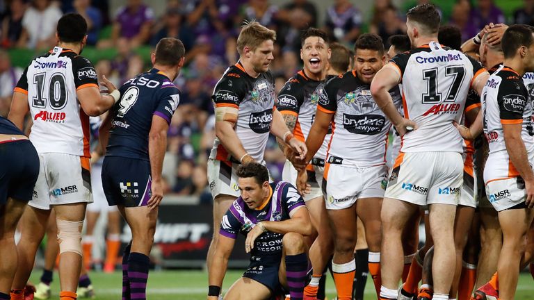 Billy Slater of the Melbourne Storm looks dejected as the Tigers celebrate their win