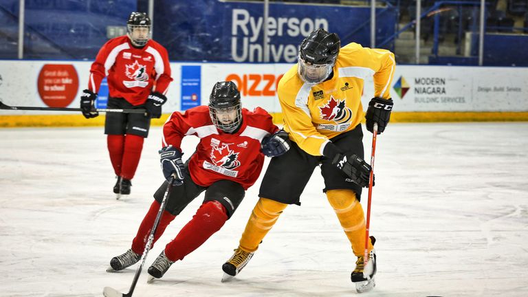 Blind ice hockey players Simon Richard and Vince Ryan vie for possession