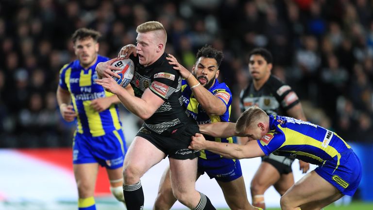 Hull FC's Brad Fash (left) is tackled by Warrington Wolves' Brad Dwyer