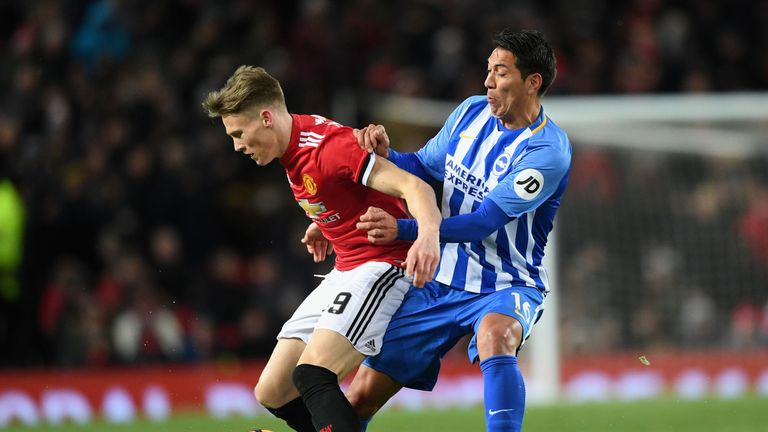 Scott McTominay of Manchester United is challenged by Leonardo Ulloa of Brighton during the Emirates FA Cup Quarter Final between Manchester United and Brighton & Hove Albion at Old Trafford on March 17, 2018 in Manchester, England